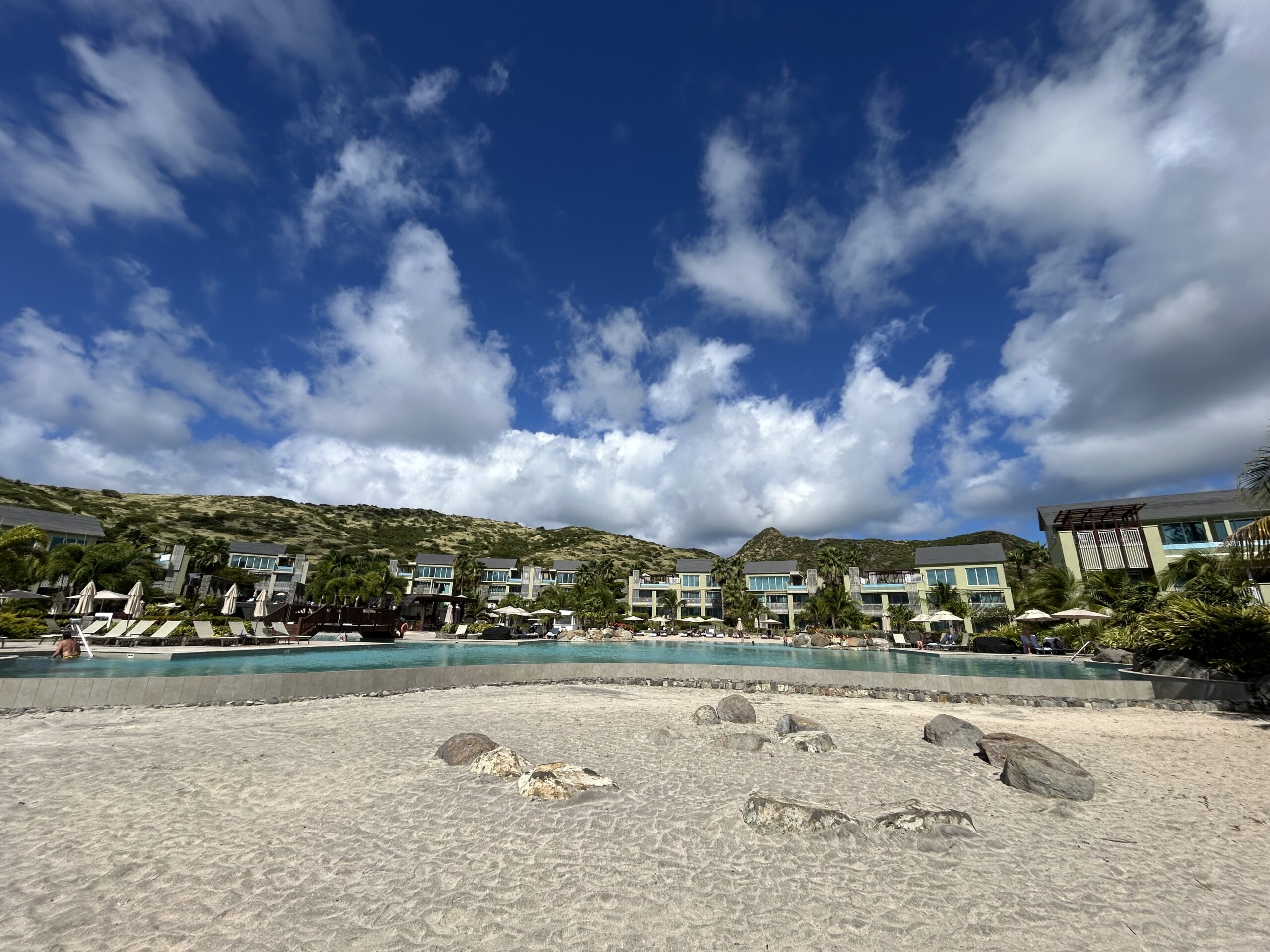 View of the pool and hotel villas from the beach