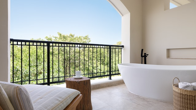 hotel room balcony with a private soaking tub