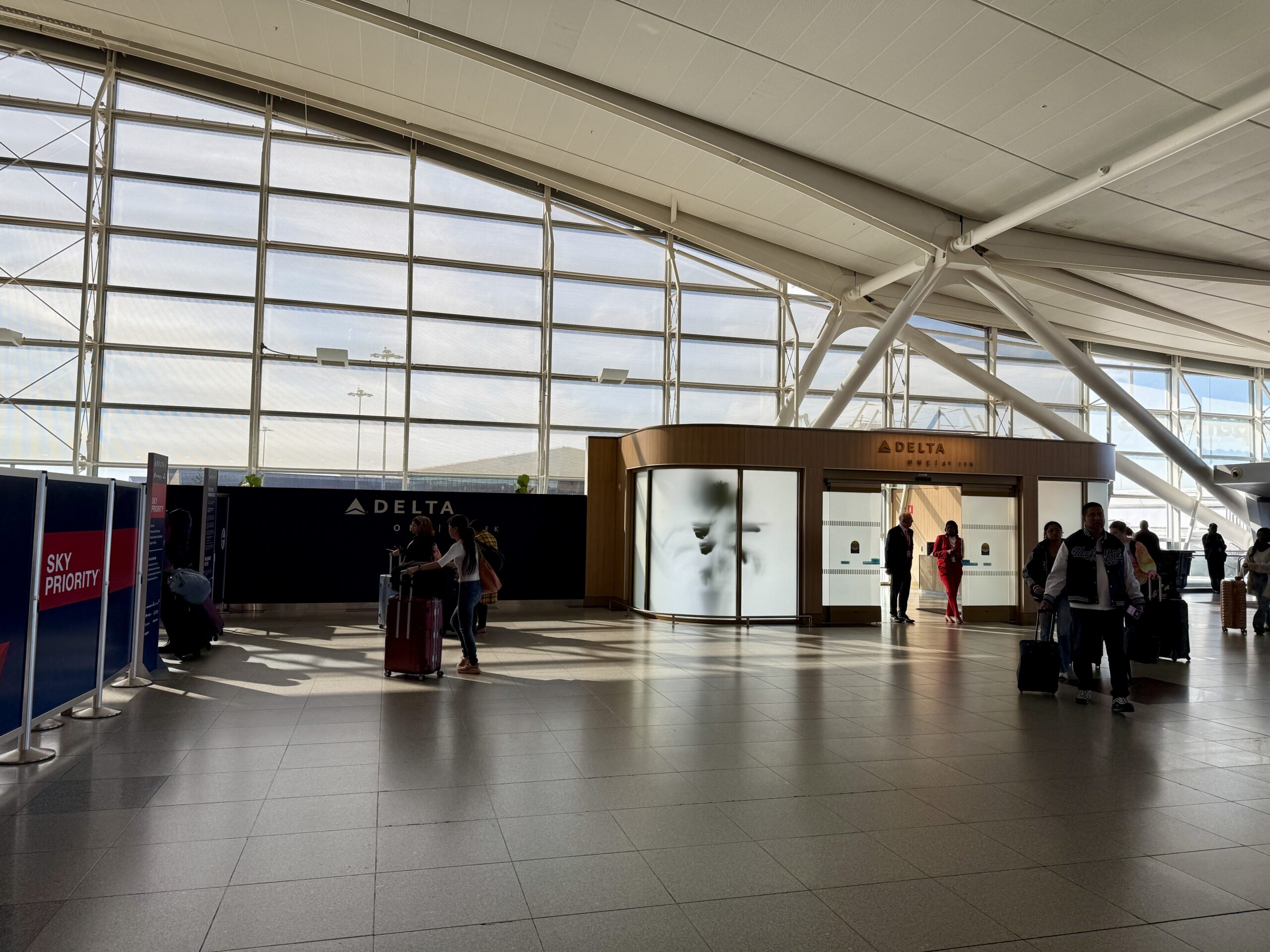 exclusive delta airport entryway with travelers standing outside