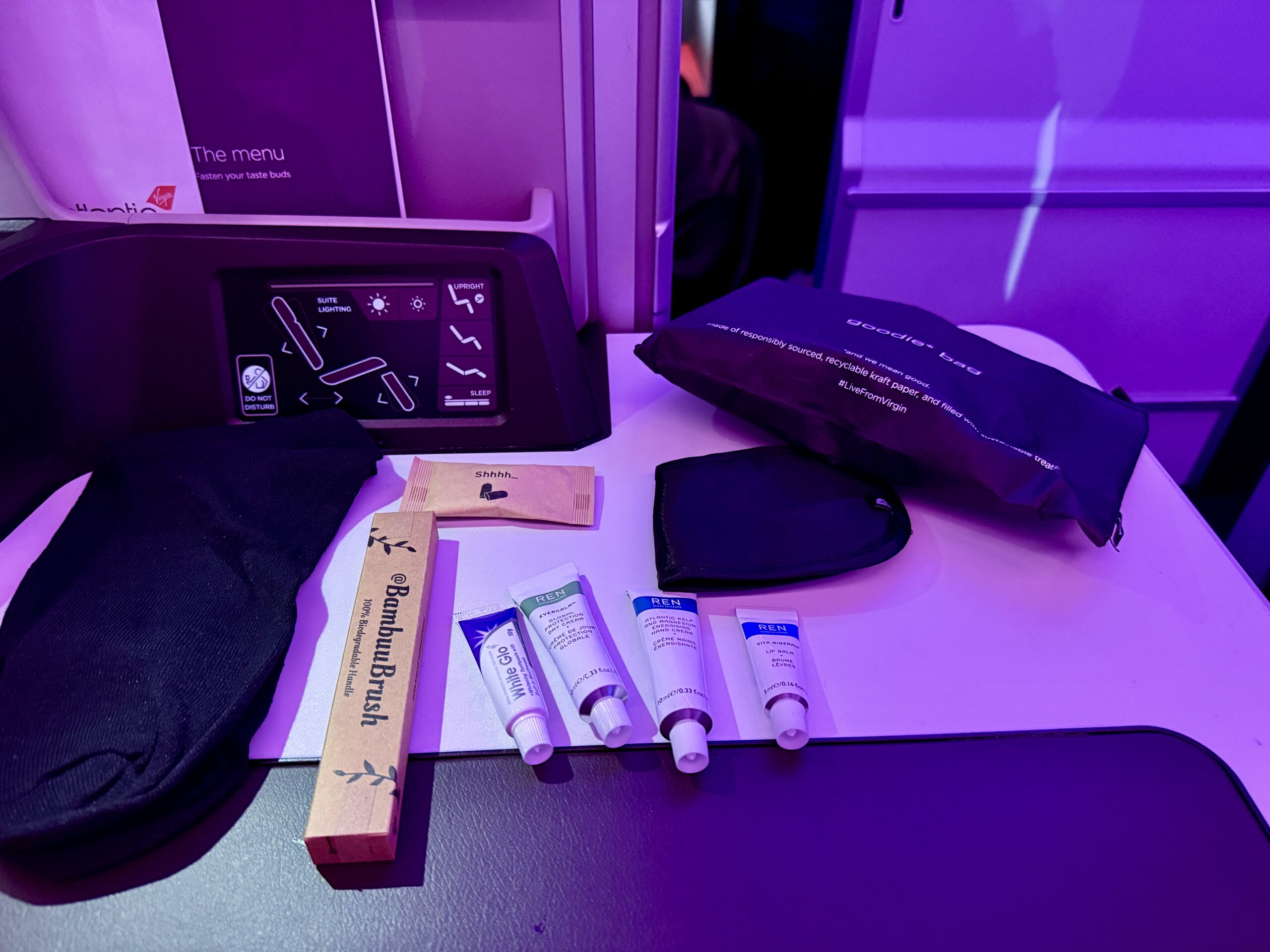 amenity kit contents on console table on a plane