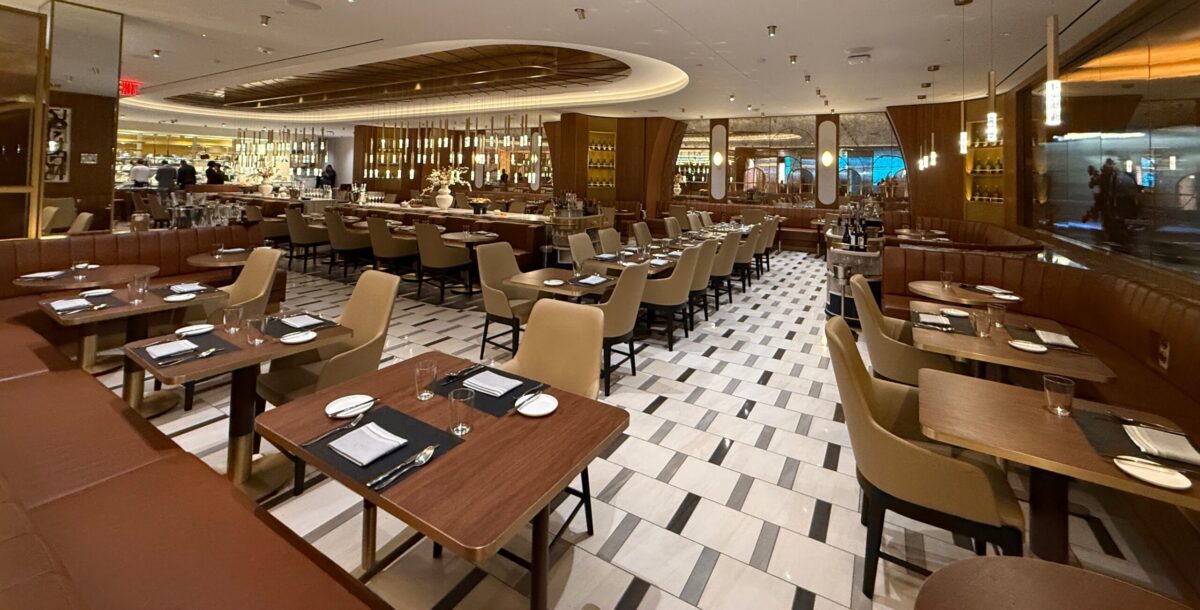 chairs and tables inside the delta one lounge at jfk