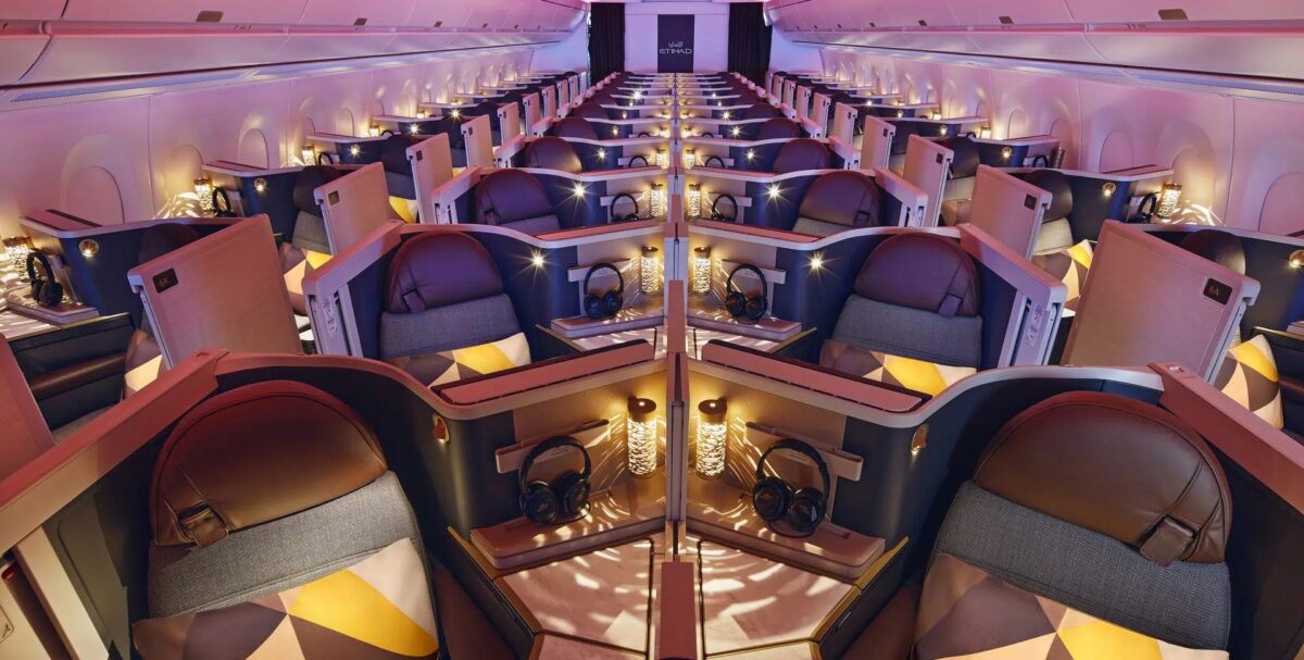 rows of business class seats with mood lighting