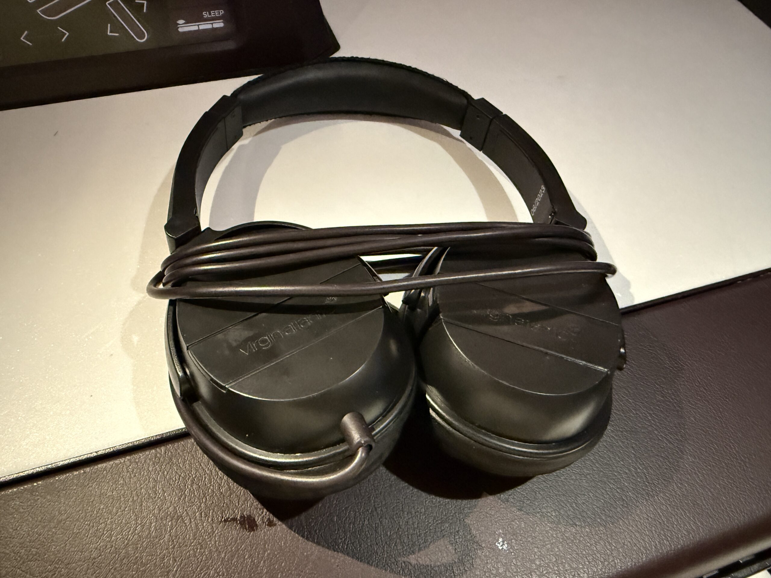 a pair of black headphones with a cord wrapped around 