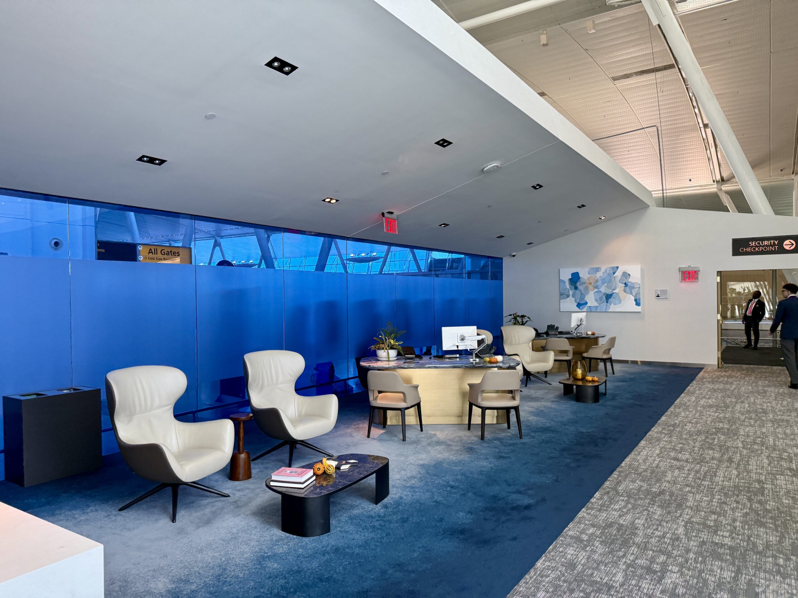 seating and check in desks on blue carpet in front of blue windows