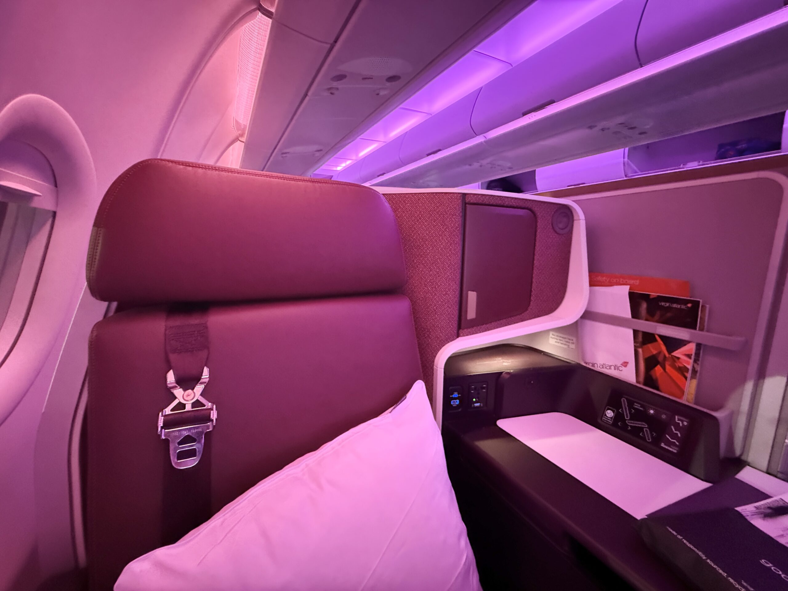virgin atlantic business class seat with a white pillow