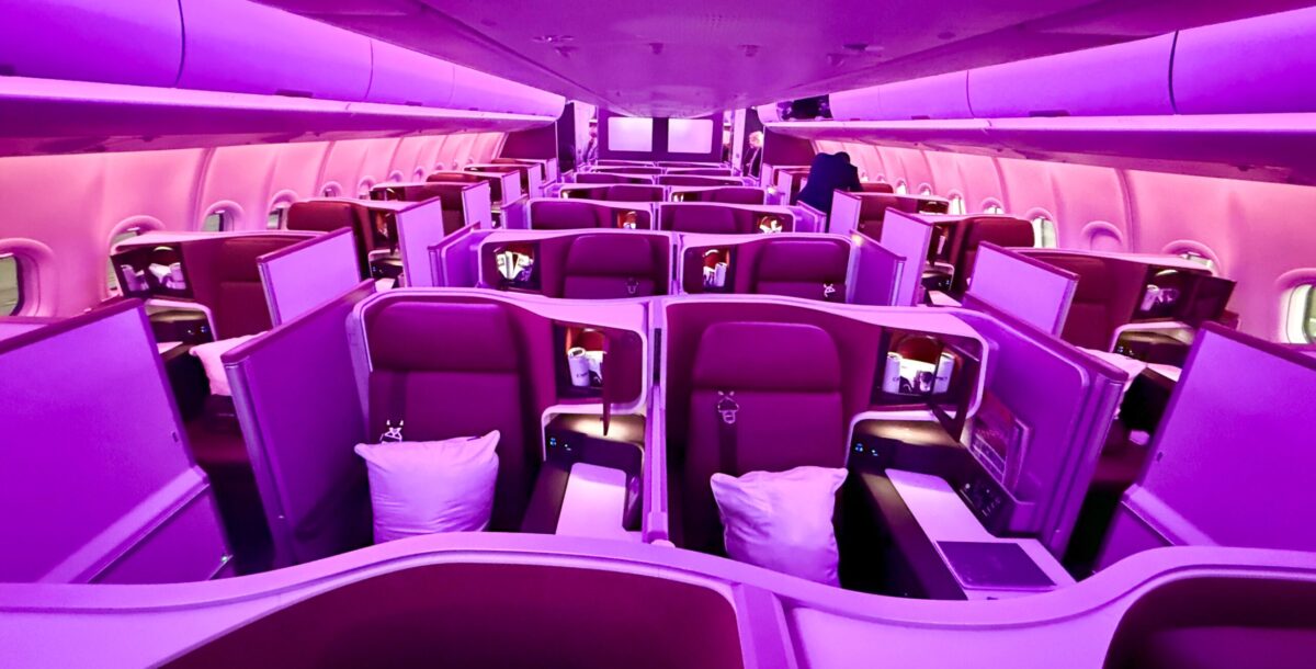 virgin atlantic upper class business cabin seats with purple and red lighting