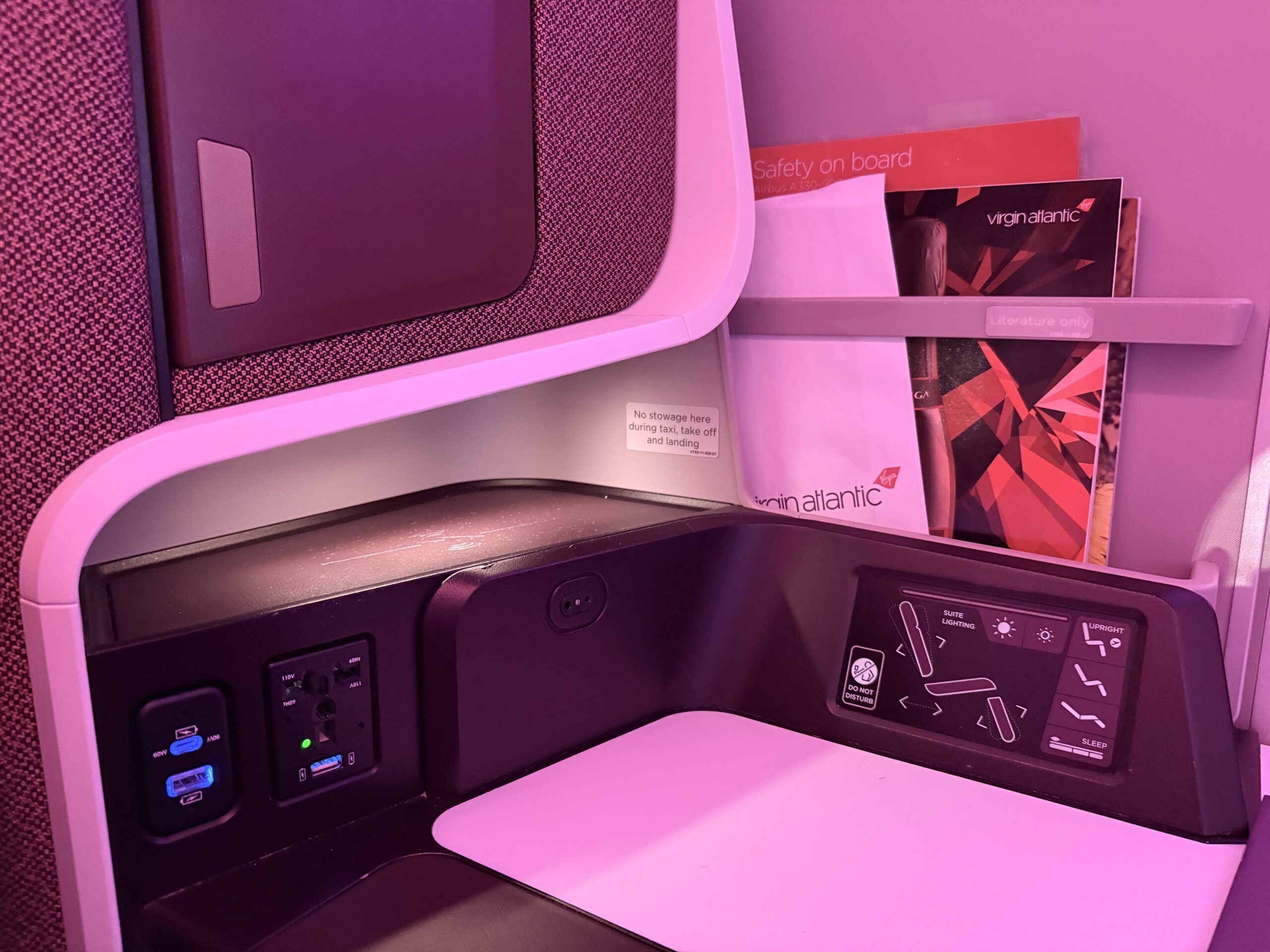 charging outlets and seat controls in a business class seat